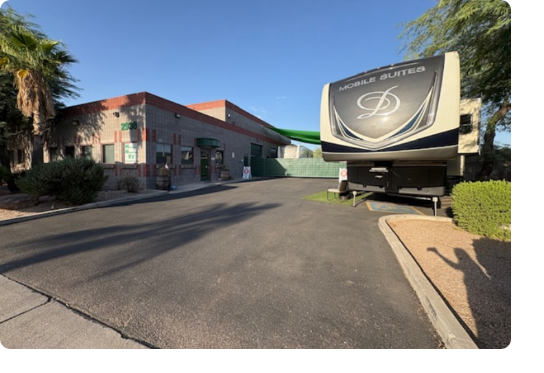 A large rv parked in front of a building.