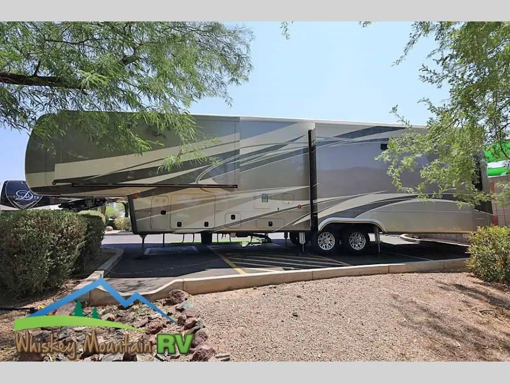 A large rv is parked on the side of a road.