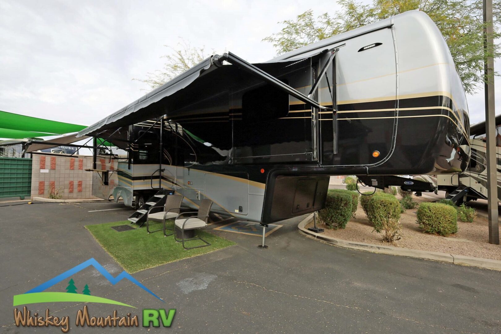 A large rv parked in the driveway of a house.