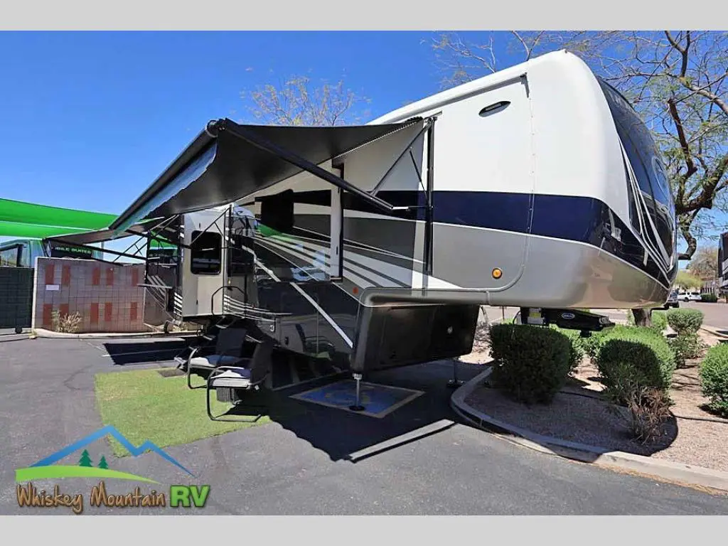 A large rv parked in the driveway of a house.