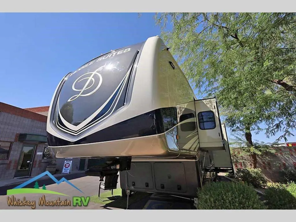 A large rv parked in the driveway of a house.